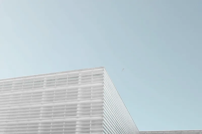 grey concrete building under clear blue sky